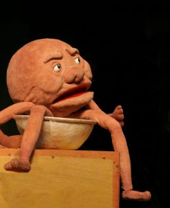 Puppet of Albert the Magic Pudding sitting in his pudding bowl